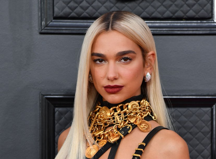 Dua Lipa wearing Versace on the Grammys 2022 red carpet.