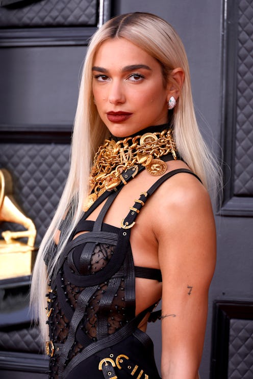 Dua Lipa attended the 64th Annual Grammy Awards wearing a strappy bondage bustier dress.