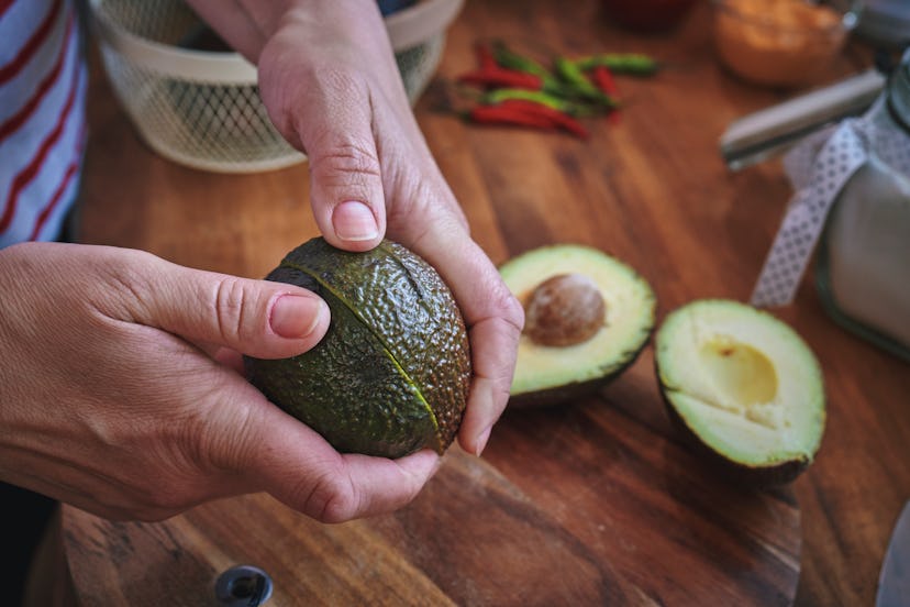 Cutting Avocado on Wooden Cutting Board