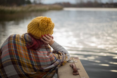 young woman sitting on the dock