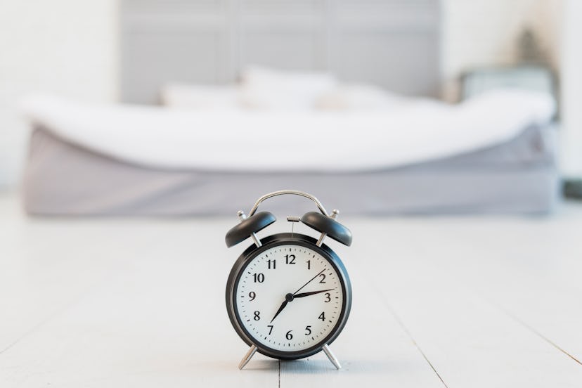 snooze floor near bed with white linen