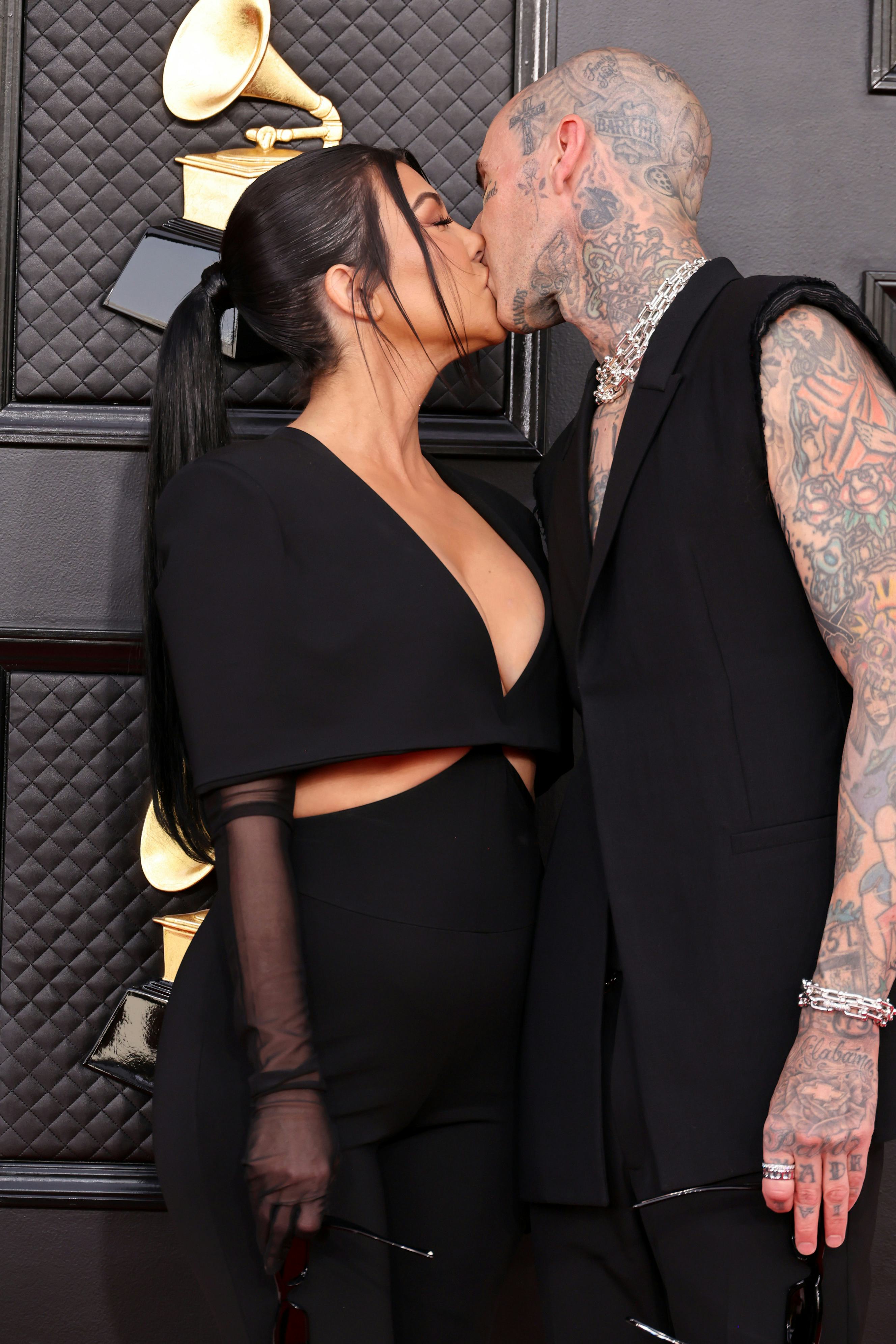 Kourtney Kardashian and Travis Barker kissing at the 2022 Grammys.