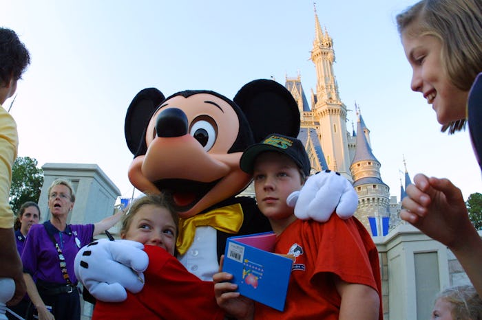 397155 01: The Walt Disney character Mickey Mouse greets children at Magic Kingdom November 11, 2001...