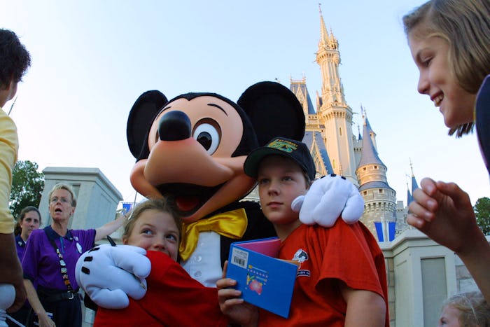 397155 01: The Walt Disney character Mickey Mouse greets children at Magic Kingdom November 11, 2001...
