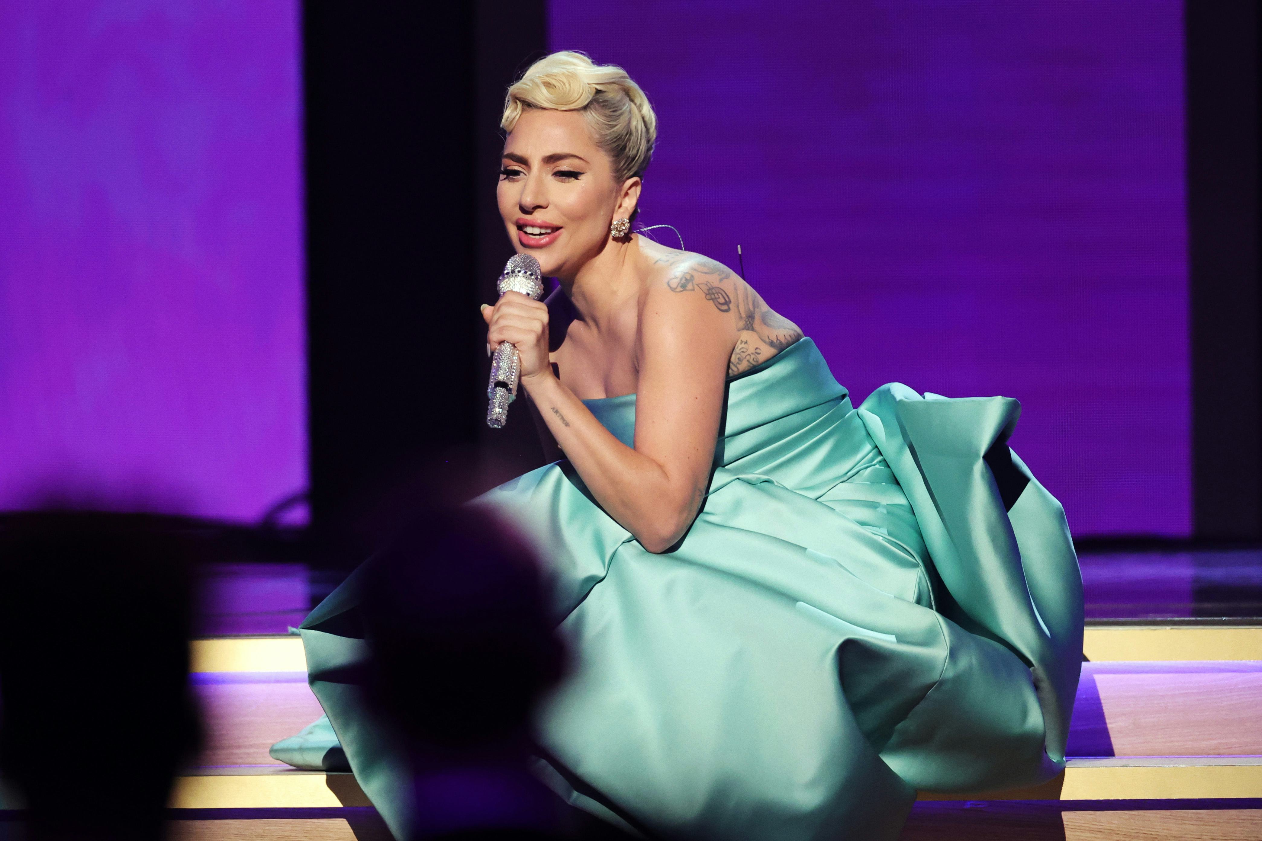 The Meaning Behind Lady Gaga's Trumpet Tattoo At The 2022 Grammys