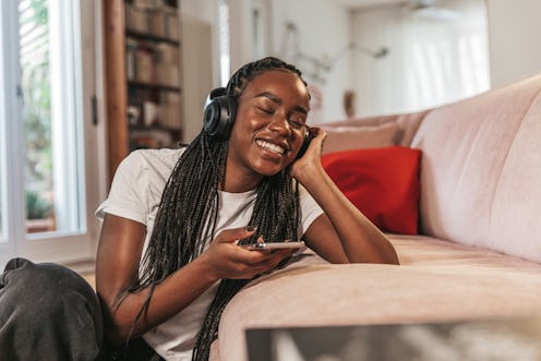 Young woman enjoying music on Spotify.