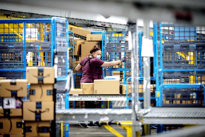 EASTVALE, CA - AUGUST 31: A worker sorts out parcels in the outbound dock at Amazon fulfillment cent...
