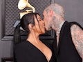 Kourtney Kardashian and Travis Barker kissing at the 2022 Grammys.