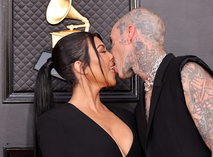 Kourtney Kardashian and Travis Barker kissing at the 2022 Grammys.