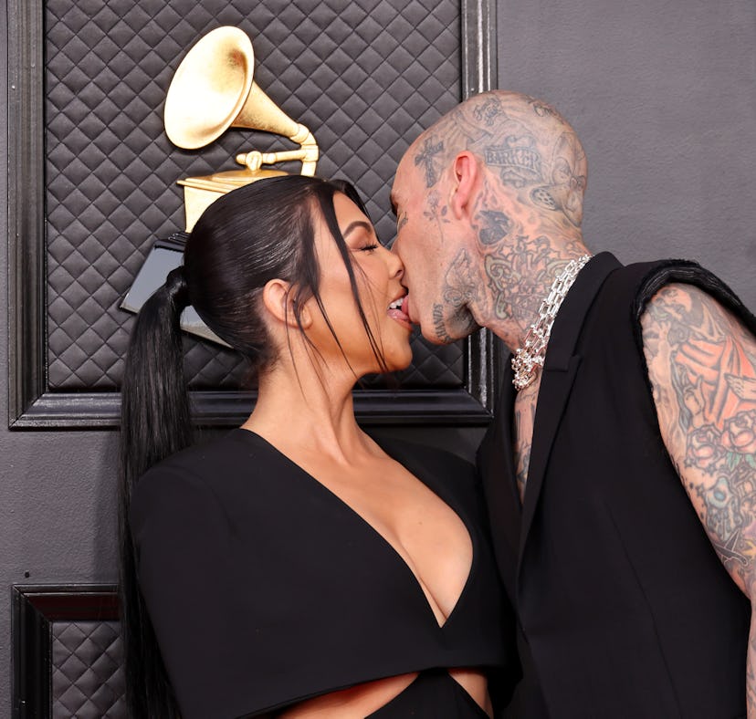 Kourtney Kardashian and Travis Barker kissing at the 2022 Grammys.