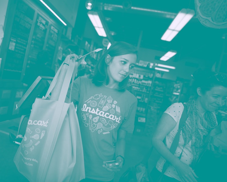 Instacart personal shopper, Sydney Hollingsworth, carries a customer's order after purchasing it at ...