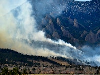 BOULDER, CO - MARCH 26: The NCAR fire burns in the foothills south of the National Center for Atmosp...