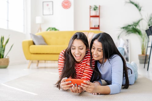 Two friends watching TikTok videos on phone together