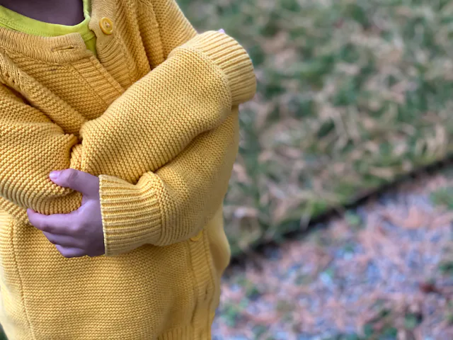 little girl folds her arms in protest