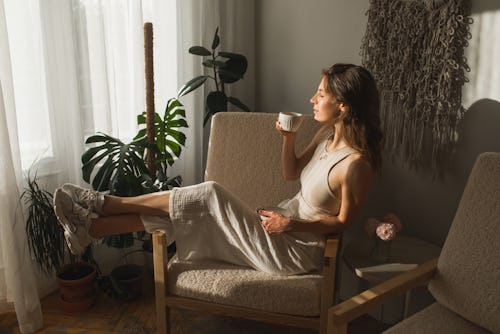 A woman has a morning coffee. Here's your daily horoscope for today, April 7, 2022.