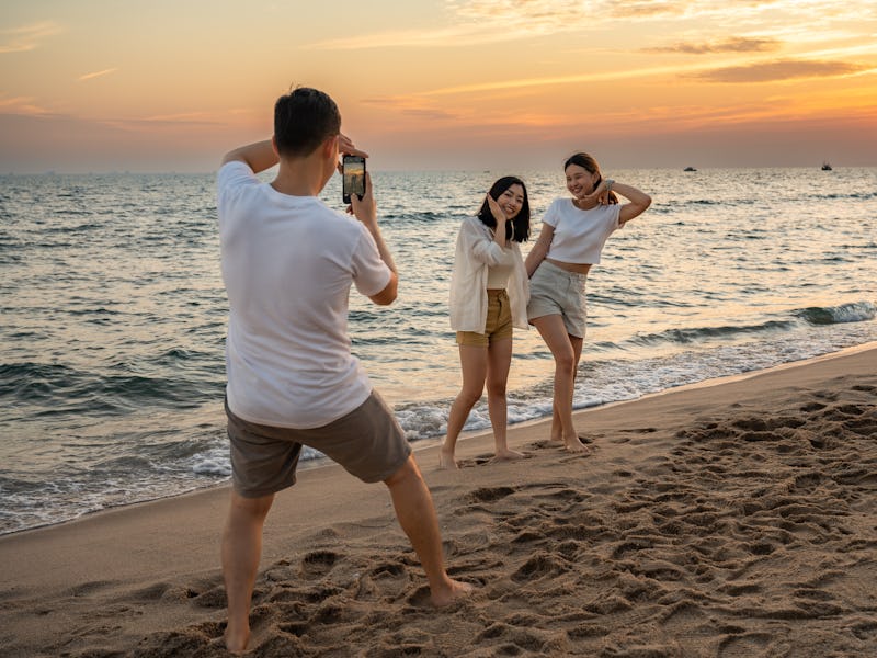 Group of happy friends taking selfie and having fun with beach sport games - Summer joy concept and ...