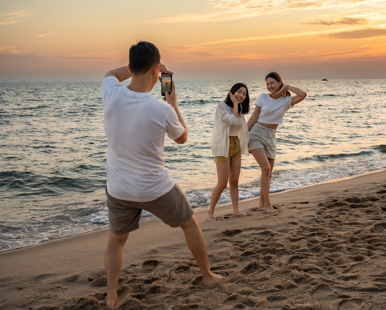 Group of happy friends taking selfie and having fun with beach sport games - Summer joy concept and ...