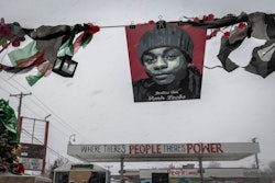 TOPSHOT - Amir Locke's picture is seen during a heavy snowstorm at George Floyd Square in Minneapoli...