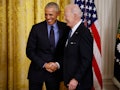 WASHINGTON, DC - APRIL 05: Former President Barack Obama (L) and U.S. President Joe Biden shake hand...