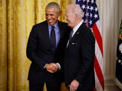 WASHINGTON, DC - APRIL 05: Former President Barack Obama (L) and U.S. President Joe Biden shake hand...