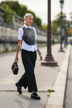 PARIS, FRANCE - SEPTEMBER 28: Amalie Gassmann wears a white shirt, a black leather with embroidered ...