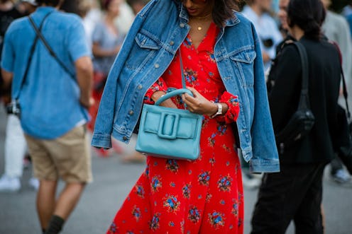 COPENHAGEN, DENMARK - AUGUST 09: A guest wearing denim jacket, red dress, blue bag is seen outside S...