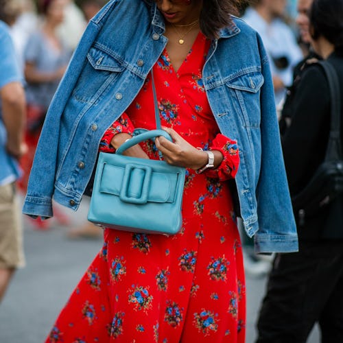 COPENHAGEN, DENMARK - AUGUST 09: A guest wearing denim jacket, red dress, blue bag is seen outside S...