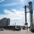 SpaceX's first orbital Starship SN20 is stacked atop its massive Super Heavy Booster 4 at the compan...