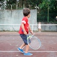 Boy playing tennis with his mother, Oleiros, A Coruna, Galicia, Spain