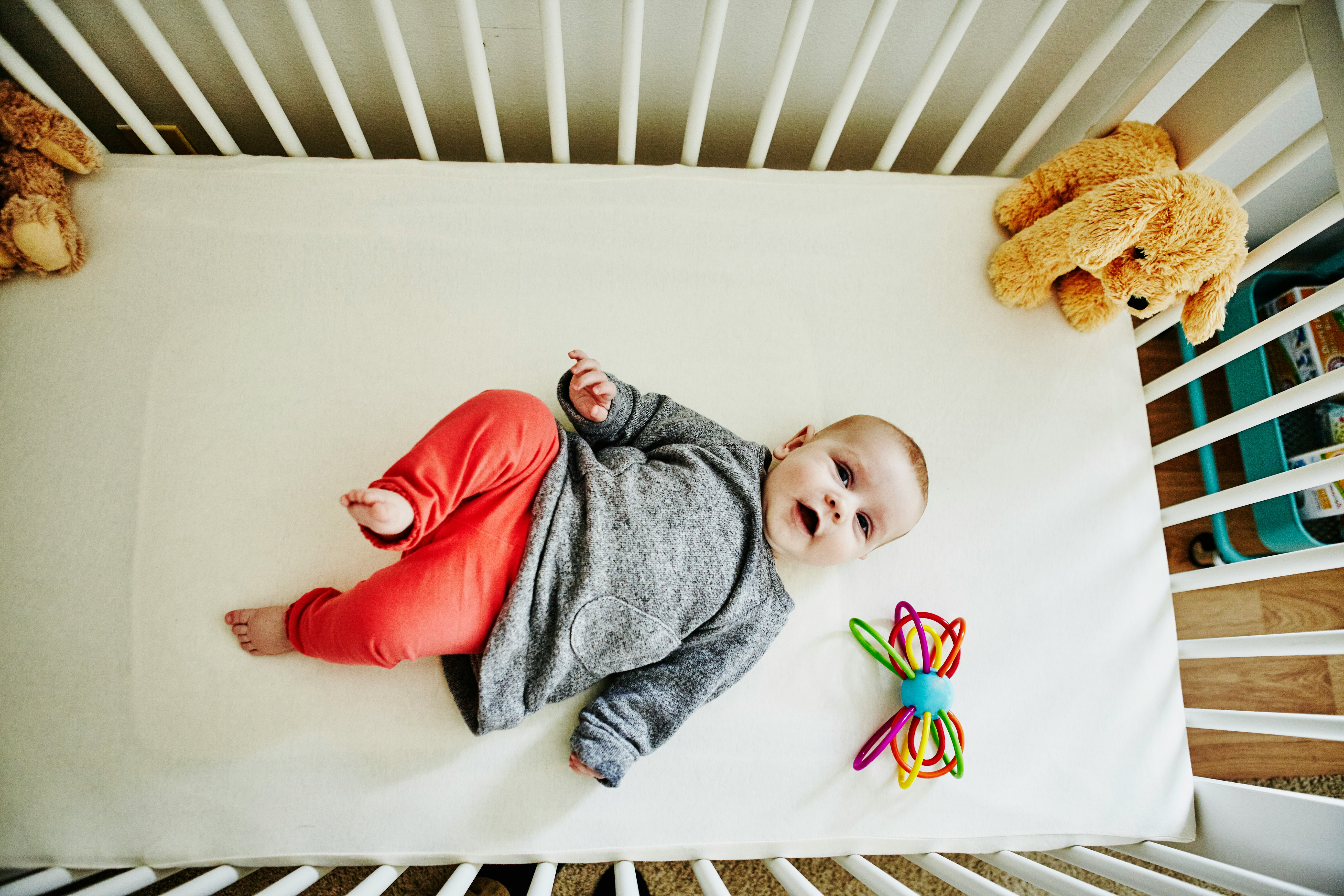 Baby looks up deals at ceiling and smiles