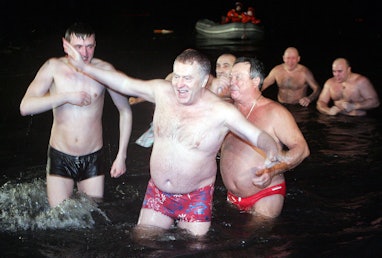 Russian liberal-democratic party leader Vladimir Zhirinovsky enters a pond in  Moscow after the Orth...