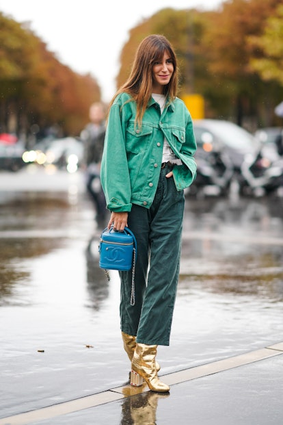 PARIS, FRANCE - OCTOBER 01: Gala Gonzalez wears a green denim jacket, a white top, green pants, gold...