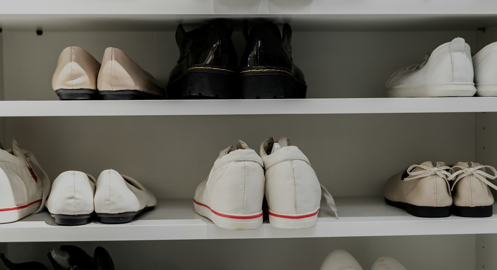 Rack of shoes at the entrance of home.