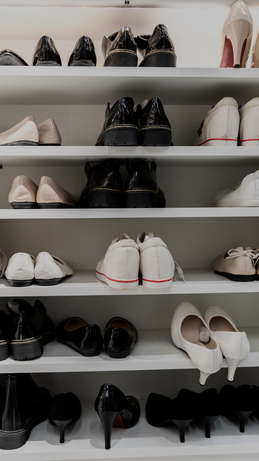 Rack of shoes at the entrance of home.