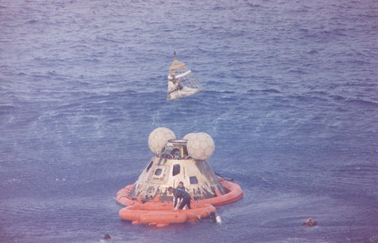 Apollo 13 Recovery Area, 1970. Astronaut John L. Swigert Jr., command module pilot, is lifted aboard...