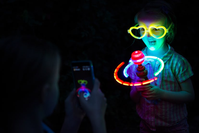 Even just playing with glow sticks can keep kids entertained while camping.