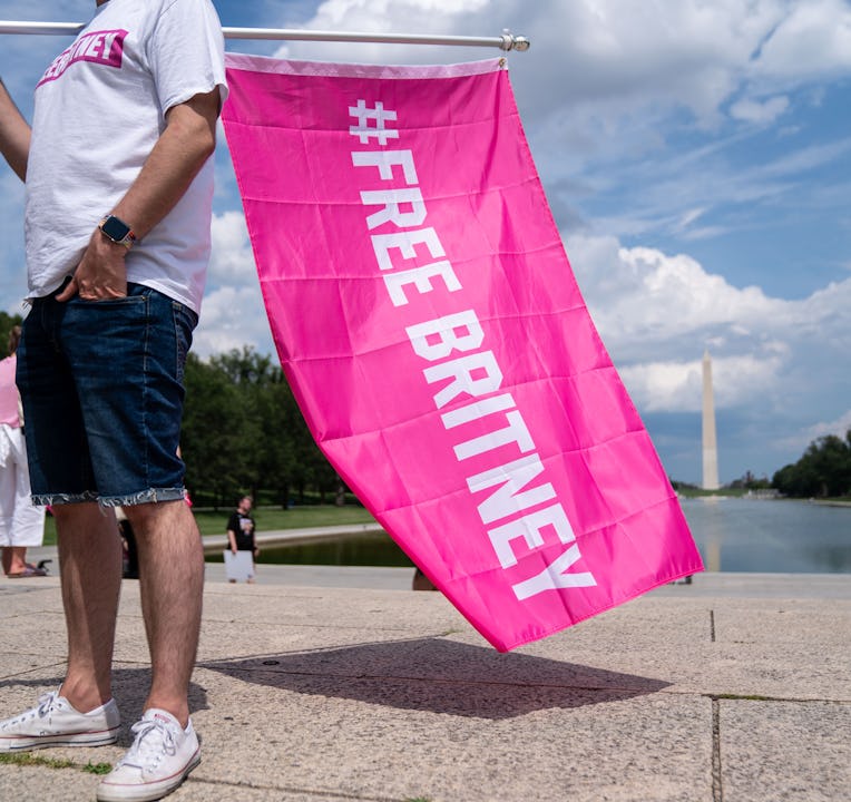 WASHINGTON, DC - JULY 14: Corey Baily, 33, of DC holds a flag as he and other supporters of pop star...