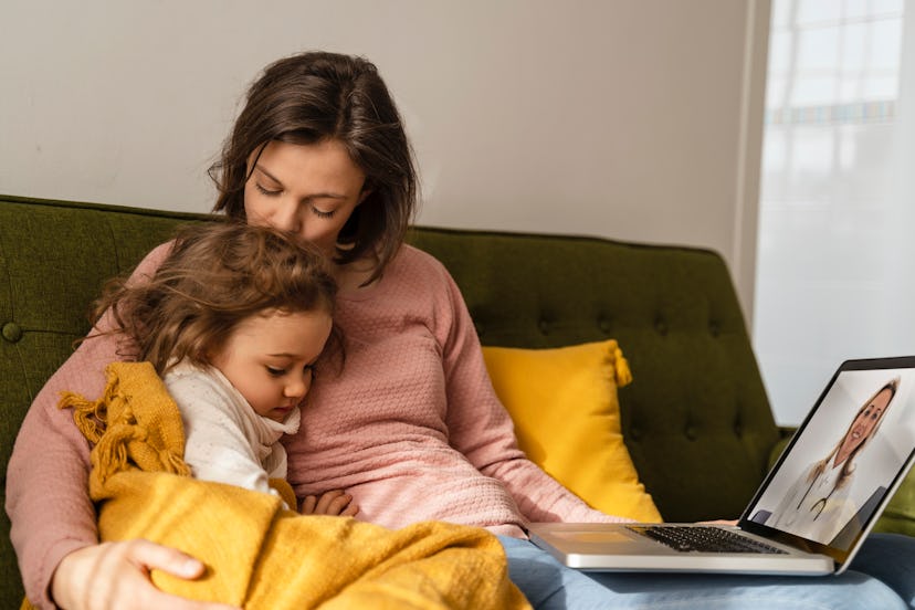 A mom and daughter have a virtual doctor visit to examine the flu symptoms that everyone is getting ...