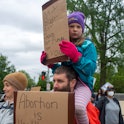 Abortion-rights activists hold signs during a Mothers Day demonstration outside the U.S. Supreme Cou...