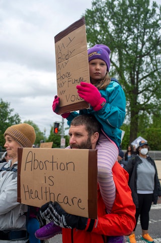 Abortion-rights activists hold signs during a Mothers Day demonstration outside the U.S. Supreme Cou...