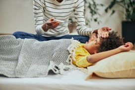 A mom takes care of her sick child at home as the flu is circulating right now.