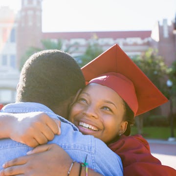 A woman in a graduation cap and gown hugging a loved one. The graduating class of Wiley College just...