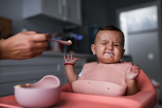 Baby sitting in highchair refusing to eat.