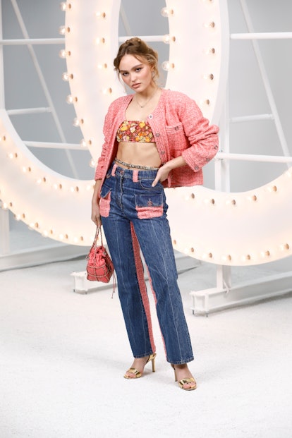 Lily Rose Depp in floral bandeau, Chanel tweed jacket, and jeans
