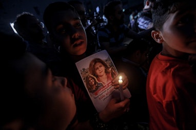 11 May 2022, Palestinian Territories, Gaza City: Children take part in a candlelight vigil to denoun...
