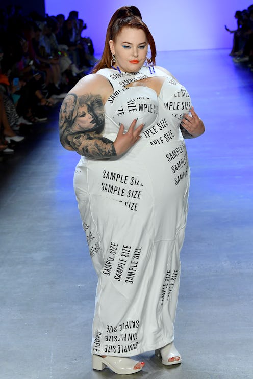 Tess Holliday walks the runway for Chromat Spring wearing a dress labeled sample size as a statement...