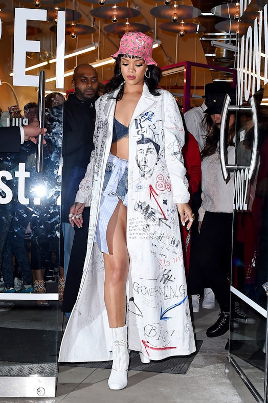 Rihanna in denim bralette and shorts with duster coat on top