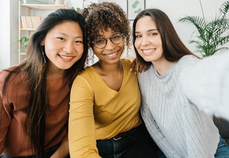 three friends posing for a selfie as they discuss how the new moon in gemini 2022 will affect them 