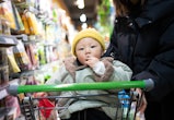 Young asian woman shopping in supermarket with child