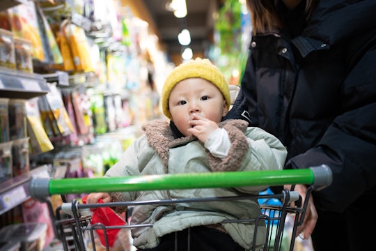 Young asian woman shopping in supermarket with child